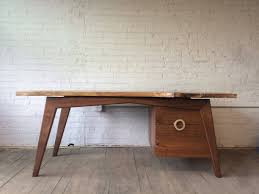 I like that this desk has a minimalist look to it, but the complex joinery techniques used bring it to the next level. Custom Mid Century Modern Inspired Walnut Slab Desk By Powell Woodworks Custommade Com