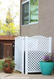 Antique shutters affixed to wood frame, create a screen cover for window and ac hvac unit. How To Hide An Outdoor Ac Unit My Frugal Adventures