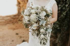 A cascading bouquet is an arrangement of flowers that literally cascades from the bride's hands, creating a natural, trailing effect. Cascading Bouquet With Babies Breath Eucalyptus And Roses Flower Bouquet Wedding Cascading Wedding Bouquets Bridal Bouquet Flowers