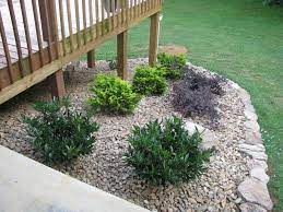 Landscaping will make your deck and yard look truly finished. Lightsonthelake Rock Garden Around Deck Done Landscaping Around Deck Rock Garden Landscaping Garden Landscape Design