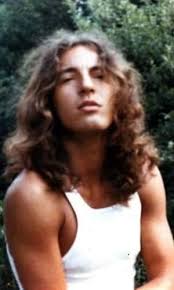 In this 1971 photograph, Bruce Springsteen is captured at a pivotal  moment—on the edge of becoming one of America's most enduring rock icons.  At just 21 years old, he had already cycled