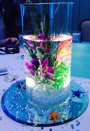 Beach themed party and coastal table setting. Under The Sea Centerpiece Led Lit Up With Seaweed Beautiful For Weddings Quince Or A Sweet 16 Sea Wedding Theme Little Mermaid Wedding Sea Wedding