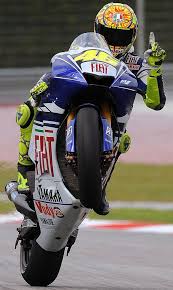 Italian Rider Valentino Rossi Of Fiat Ya Italian Rider Valentino Rossi Of Fiat Yamaha Team Does A Wheelie At T Valentino Rossi Motogp Valentino Rossi Valentino