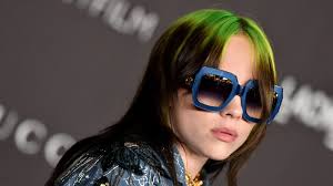 The story about the green hair is that her hair was dark grey, but when her hair dye person tried to re dye it grey, her hair started falling out and became bright purple. Billie Eilish Has Light Brown Hair In Xanny Music Video See Video Allure