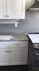 Santa Cecilia Light Granite Taupe Glass Backsplash White Cabinets White Modern Kitchen Glass Backsplash Kitchen Grey Granite Countertops