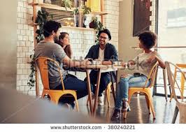 Young People Sitting At A Cafe Table Group Of Friends Talking In A Coffee Shop People Sitting Friends Cafe Friend Photoshoot