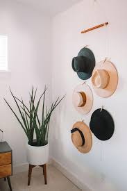 For example, this idea utilizes a tree design mounted on the wall. Create A Hat Wall Display