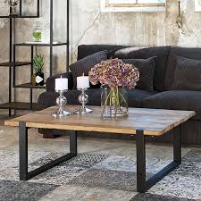 Chic living room with botanical prints in silver frames over green sofa, oil rubbed bronze sconces, french industrial cocktail table and david hicks la fiorentina pillow. Industrial Coffee Tables Crafted From Reclaimed Wood Modish Living