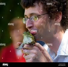 Daniel Macht, of Capitol Weekly, kisses a frog before competing in the  media category during the Calaveras frog-jumping contest for lawmakers