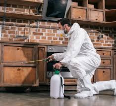 Pest technician preparing service equipment