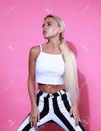 Sexy Blonde Young Model Posing In Strip Trousers And White Short Top On  Pink Background. Stock Photo, Picture and Royalty Free Image. Image  63865244.