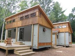 Compact Modular Pre Fab Cottage Made From Local Materials Sits Amongst Trees Near Traverse City Small Wooden House Wooden House Plans Container House