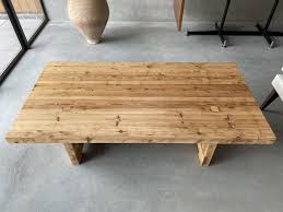 It has a unique metal wire base that is built like a sled, the reclaimed wood top overlaps onto the side and creates two triangle shapes. A 1970s Chunky Pine Coffee Table In Furniture
