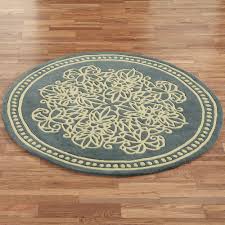 While living rooms and bedrooms often feel bare without a rug underfoot, we often don't think twice about leaving rugs out but here, a small, rectangular rug sits under a round table. Lucia Lace Wool Round Area Rugs