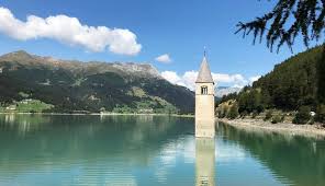 Curon's landmark is the steeple in the lake. Kirchturm Im Reschensee Reschenpass Sudtirol
