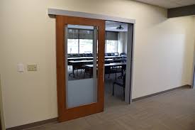 Room dividing doors make a confident statement to a contemporary interior. Office Glass Sliding Doors Modern Workplaces Ad Systems