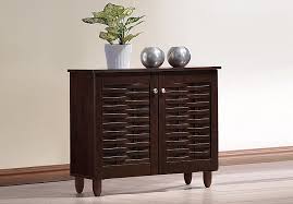 A stylish solution for keeping your entryway tidy, this shoe storage cabinet bench allows you to stash shoes out of sight while also giving you a place to sit to take your shoes on and off. Amazon Com Wholesale Interiors Baxton Studio Winda Modern And Contemporary 2 Door Dark Brown Wooden Entryway Shoes Storage Cabinet Furniture Decor