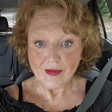 Yogurt with paper covering underneath foil and lid