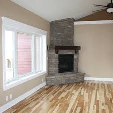A small sofa and two armchairs provide seating. Corner Stone Fireplace Houzz