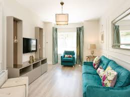 Furnishings include a sofa set and a pair of armchairs with a coffee table. Design Dilemma How To Create Focus In A Living Room With No Fireplace