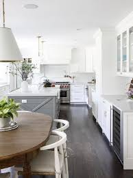 Riftsawn oak cabinetry sports a rich espresso finish in this modern kitchen. Dark Wooden Floors White Cabinets