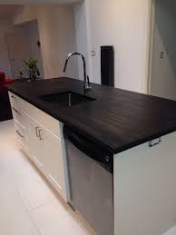 My obsession with black kitchen countertops only grew when i came across the photo below. Ebony Butcher Block Island Kitchen Renovation Ebony Butcher Block Countertops Stain Butcher Block Countertops