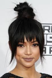 Today, more and more women experiment with updos with bangs, which is why these hairstyles are now very creative. Karrueche Tran Straight Black Bun Choppy Bangs Updo Hairstyle Steal Her Style