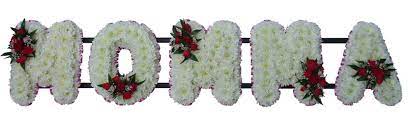 An arrangement of mixed flowers placed on a wire stand and positioned near the casket. Funeral Flowers Funeral Momma Tribute