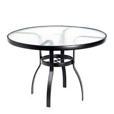 A round pedestal table that has a 1.25 thick durable laminate top that's easy to clean. Woodard Deluxe 42 Round Glass Top Dining Table 826142w