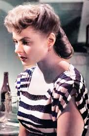 Actress, Loretta Young wearing a beautifully tailored striped suite and  Voilette hat from the film, Bedtime Story. Costume by Irene, 1941. Source.  IMDb