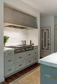 An Eye Catching Stainless Steel Hood With A Gold Trim Is Mounted In A Cooking Nook Above A Sta New Kitchen Cabinet Doors Interior Design Kitchen Kitchen Design