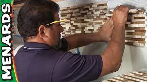 Tape off the existing countertop or backsplash and the underside of the cabinets to protect those surfaces. Tile Backsplash How To Install Menards Youtube