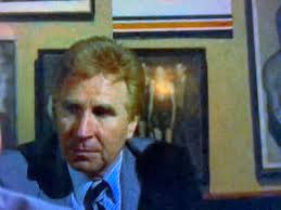 Ok, who is this guy? Now that I'm watching the episodes in order I'  noticing he's in a lot of them as a background character. I'm guessing he's  a producer or something. :