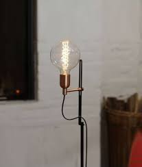 Perfect for a contemporary look in any room, this lamp features a slim steel base with a dark finish, while a long, paper drum shade caps off the single light. Slim Profile Black Floor Lamp