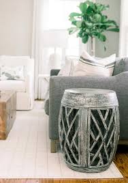 A dark green couch, because of its size and color, can overwhelm a seating area; Dark Gray Couch On White Grid Rug Transitional Living Room