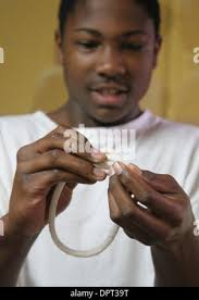 Gregory Mack, 15, successfully ties a square knot at Our Common Ground  school in Redwood City