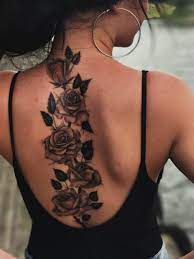 One stem rose tattoo with splashed droplets. Flower Spine Back Tattoo Girl Back Tattoos Tattoos For Women Flowers Spine Tattoos For Women