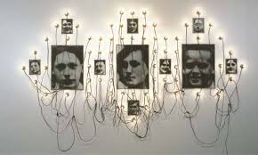 1944) réserve des suisses morts wooden shelves, three electric lamps, electric cables and photographs scattered in white linen 124 3/8 x 63 x 14in. Boltanski Christian Reserve Des Suisses Morts 1990 Mutualart
