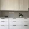 Another option with heavier and larger drawers is to use a larger cabinet pull to cover more of the drawer front. 1