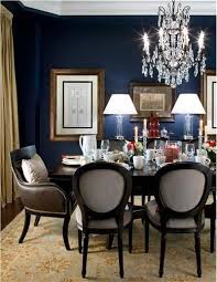 Dining room with light blue walls and wainscoting boasts blue leather round back french chairs at a brown wooden dining table and blue stripe french settees illuminated by a. Elegant Traditional Dining Room With Navy Walls Dining Room Blue Elegant Dining Room Dining Room Inspiration