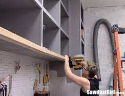 Hubby cut a few inches off the board to get the right height and left about an inch or so on the top so he could put the rollers on the door. Easy Diy Sliding Doors For Cabinets Sawdust Girl