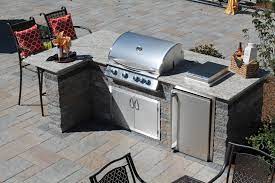 An Outdoor Kitchen With A Grill Fridge Side Burner And Storage With A Granite Counter By Bahler Outdoor Kitchen Outdoor Kitchen Design Outdoor Grill Station