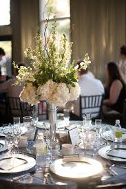 Wedding Reception Centerpieces Tall Centerpiece White And Green Flowers Round Tabl Table Flower Arrangements Round Wedding Tables Wedding Table Centerpieces