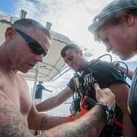 A female sergeant assists a pilot with his customs paperwork. He has just  landed his A-10 Thunderbolt II aircraft at the base to participate in air  combat training exercise COPE THUNDER '83-1 -