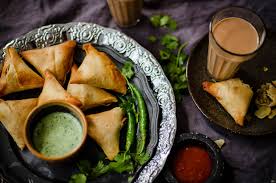 Now, add whole coriander seeds, ginger and green chilli. Samosas