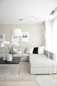 Neutral Minimalist Living Room With An Off White Sectional Sofa Beige Living Rooms Minimalist Living Room Design Minimalist Living Room