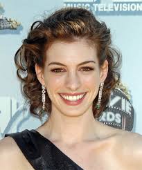 The asymmetrical pixie cut tapers with razor texturing along the perimeter. Anne Hathaway Medium Curly Updo