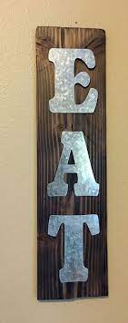 Metal Letters Attached To Stained Piece Of Wood Creating A Eat Sign To Hang In Kitchen Metal Tree Wall Art Metal Tree Tree Wall Art
