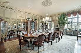 A designer who has a masterful way with color, the blue walls, ceiling and velvet blue chairs are striking combination in this stunning dining area. Formal Dining Room In Traditional Home With Wall Mirrors Stock Photo Picture And Royalty Free Image Image 6738421