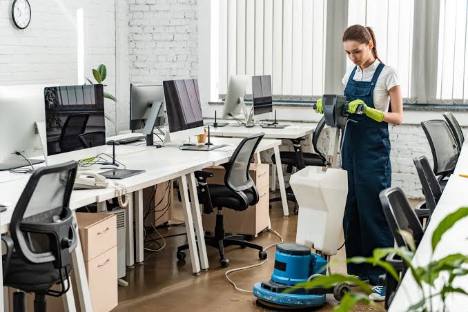 Crayford Town Centre Commercial Crew member with scrubbing brush and office sanitization kit